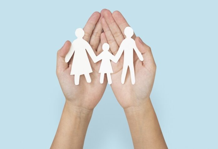 Happy family paper hand craft charity symbol